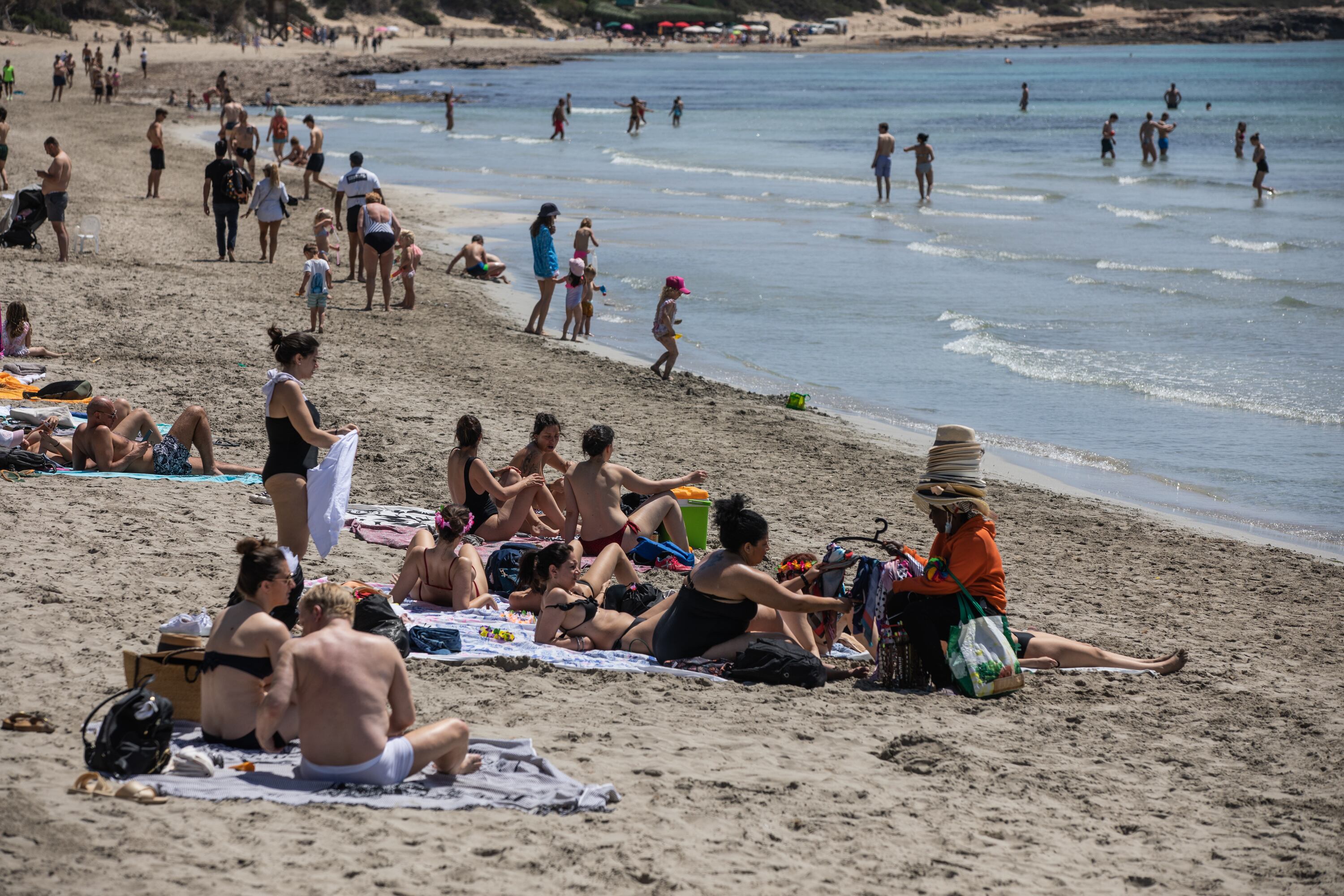 IBIZA, SPAIN - APRIL 29: Tourists enjoy the Ses Salines beach on April 29, 2022 in Ibiza, Spain. The Spanish Mediterranean island of Ibiza, summer outpost for major European nightclubs, is preparing for the first summer season since the Covid-19 pandemic forced the island to close down. (Photo by Zowy Voeten/Getty Images)