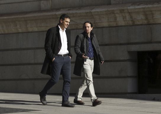 Los líderes del PSOE, Pedro Sánchez (i), y de Podemos, Pablo Iglesias, se dirigen a la sala Martínez Noval del Congreso, donde se reúnen.