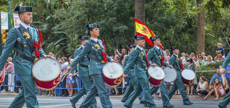 Spain - October 04, 2015: Men and women in police uniform marching with drums down the street. Guardia Civil Parade in Malaga, Spain on October 04, 2015