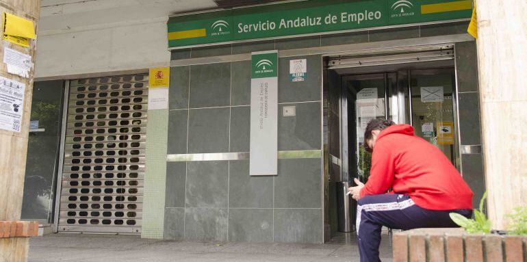 Un hombre espera ante una oficina del desempleo