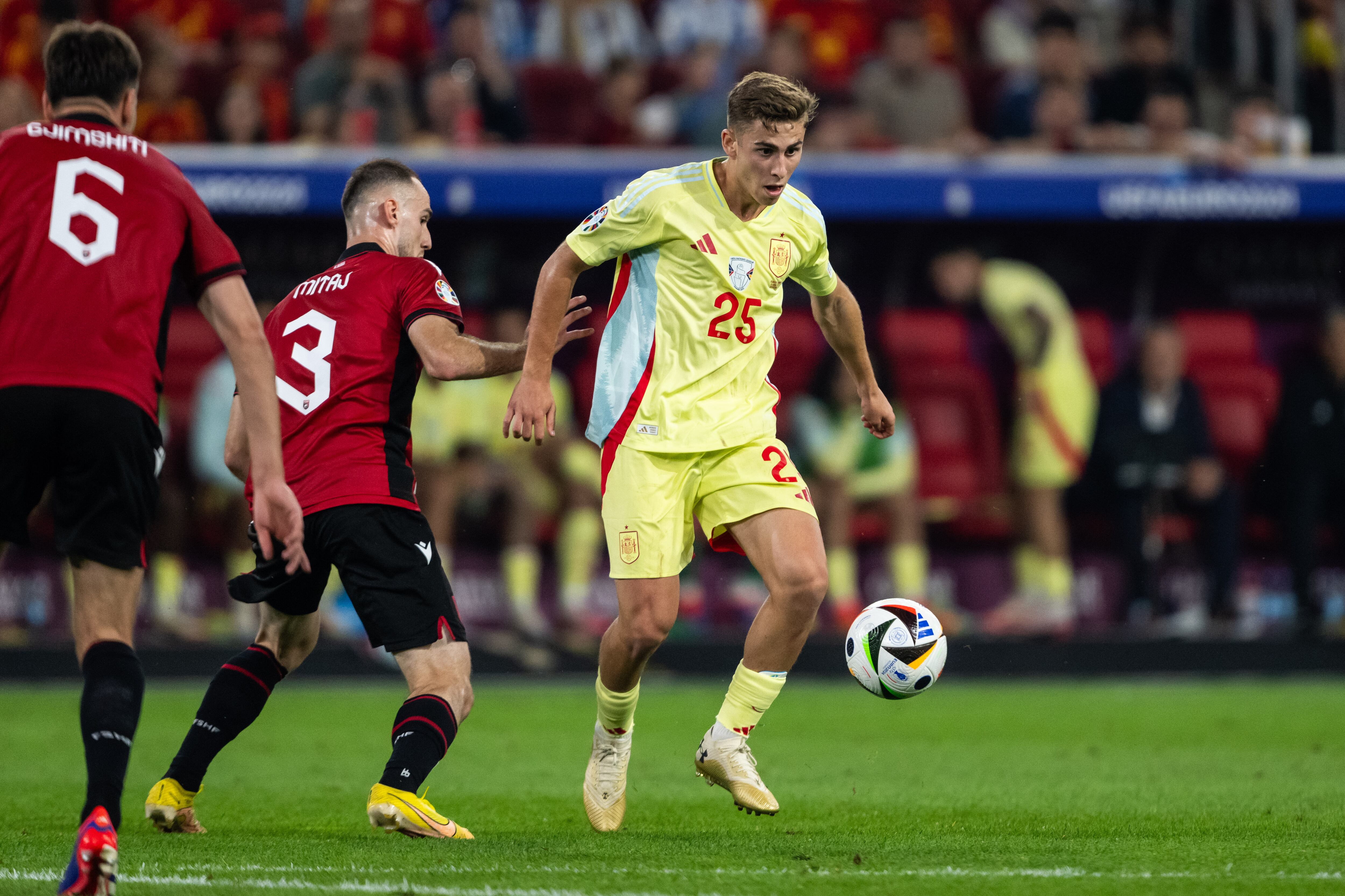 Fermin Lopez (R) of Spain is being challenged by Mario Mitaj (L) of Albania during the UEFA EURO 2024 group stage match between Albania and Spain at Dusseldorf Arena in Dusseldorf, Germany, on June 24, 2024. (Photo by Hesham Elsherif/NurPhoto via Getty Images)