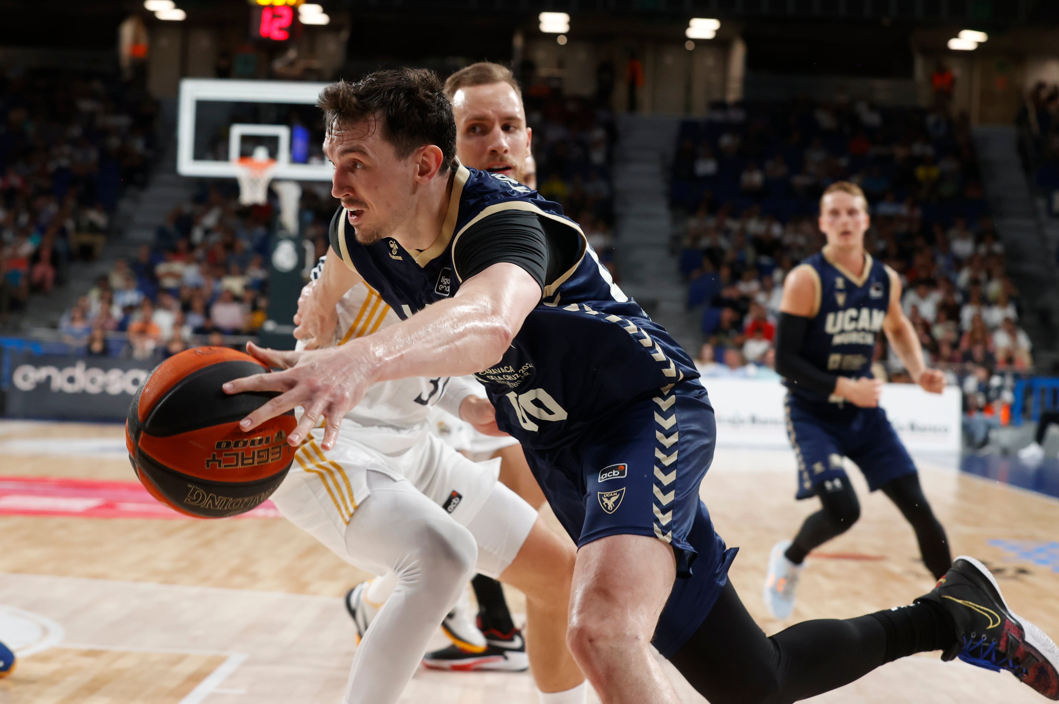 MADRID (ESPAÑA), 15/10/2023.- El alero letón del UCAM Murcia Rodions Kurucs (delante) disputa una posesión ante Dzanan Musa (detrás) alero bosnio del Real Madrid durante el partido de la jornada 5 de la Liga Endesa entre Real Madrid y UCAM Murcia este domingo en el WiZink Center de Madrid. EFE/ Juan Carlos Hidalgo
