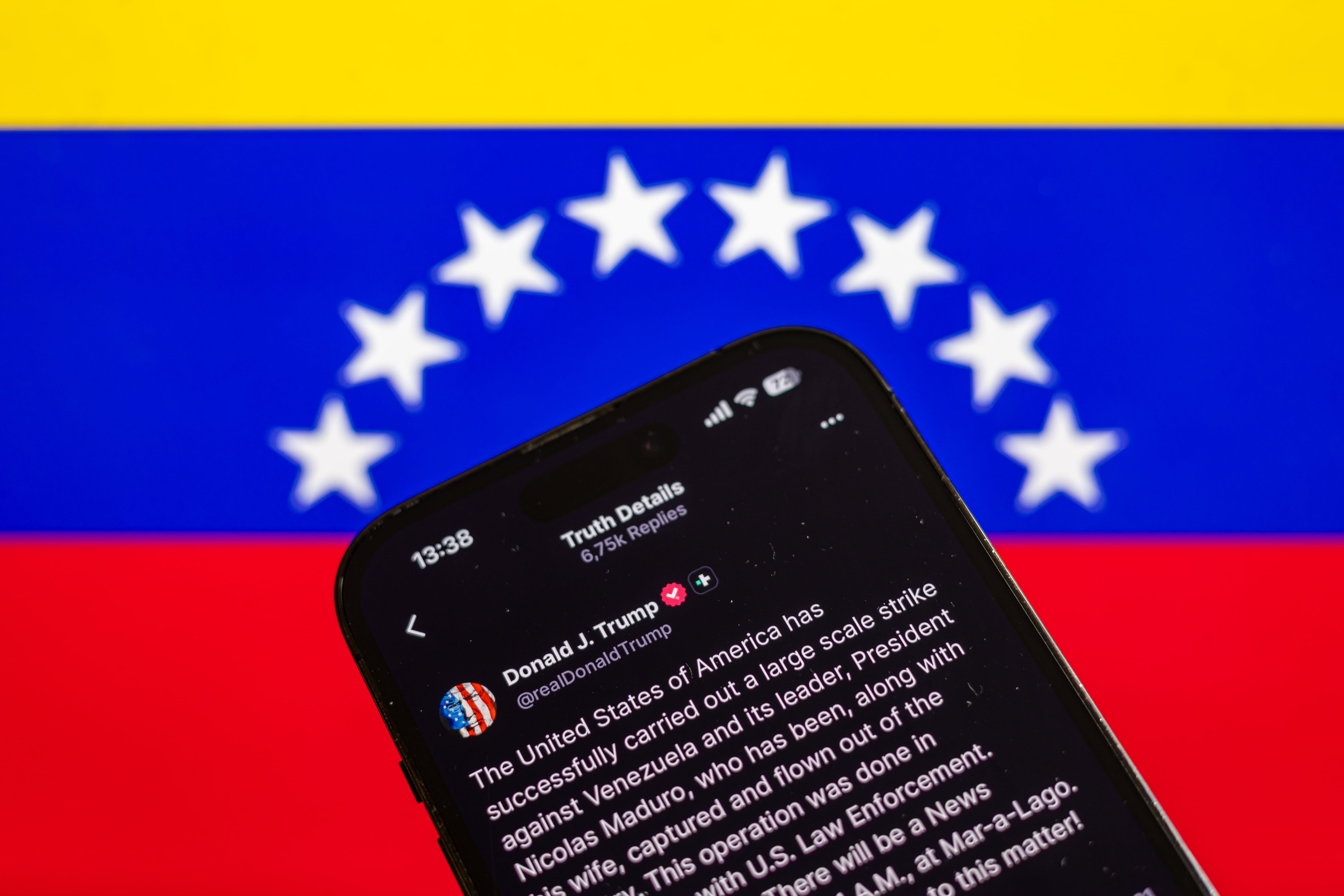PRAGUE (Czech Republic), 03/01/2026.- Illustration of a statement by US President Donald Trump posted on his Social Truth profile, pictured with the Venezuelan flag in the background, in Prague, Czech Republic, 03 January 2026. US President Trump announced that a 'large-scale strike' on Caracas resulted in the capture of Venezuelan leader Nicolas Maduro and his wife, who were reportedly flown out of the country. The Venezuelan government denounced the US operation as a 'grave military aggression'. (República Checa, Praga) EFE/EPA/MARTIN DIVISEK