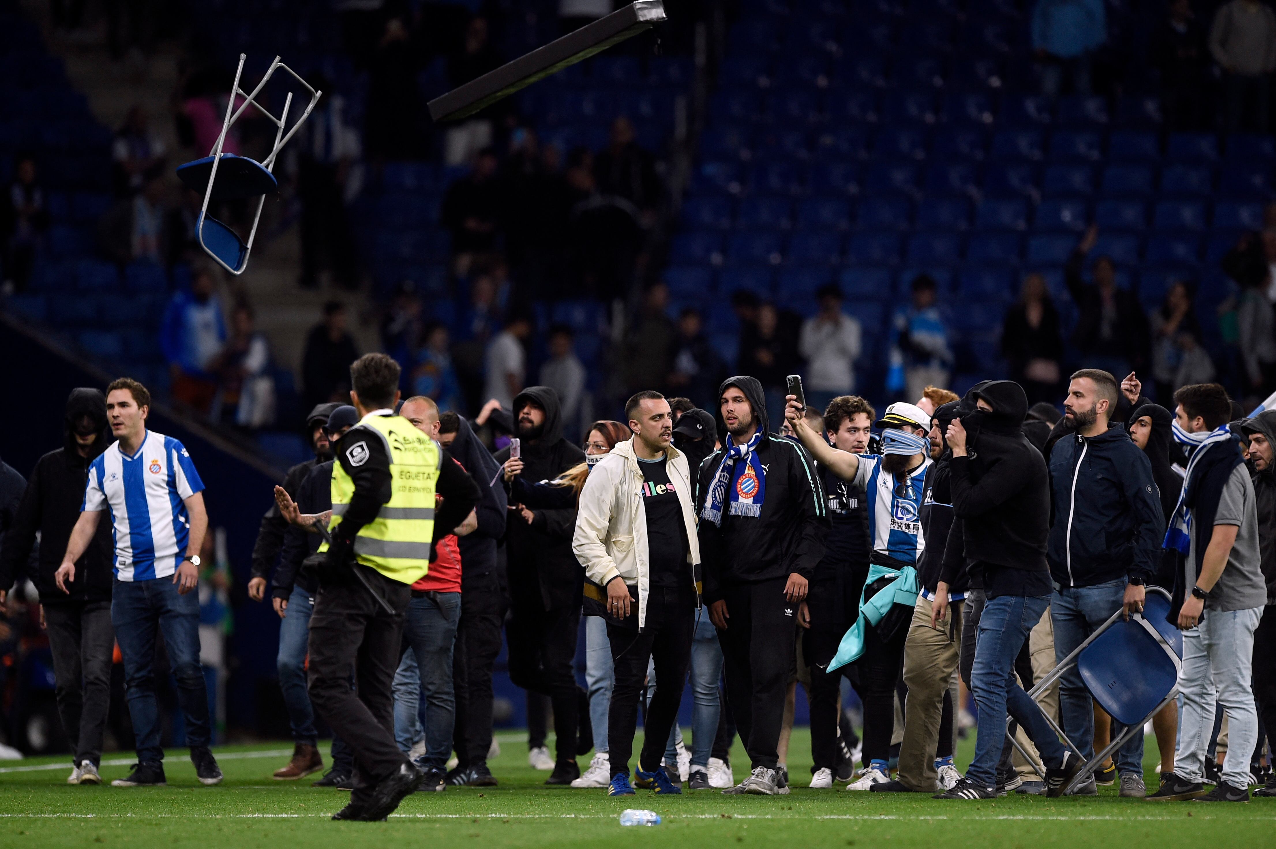 Espanyol fans react to Barcelona&#039;s victory invading the pitch after the Spanish league football match between RCD Espanyol and FC Barcelona at the RCDE Stadium in Cornella de Llobregat on May 14, 2023. Barcelona won Spain&#039;s La Liga for the first time since 2019 by thrashing Espanyol 4-2 today, wrestling the title from rivals Real Madrid. The Catalan giants clinched their 27th Spanish championship with an emphatic derby victory, with Robert Lewandowski scoring twice, alongside Alejandro Balde and Jules Kounde&#039;s goals. (Photo by Josep LAGO / AFP) (Photo by JOSEP LAGO/AFP via Getty Images)