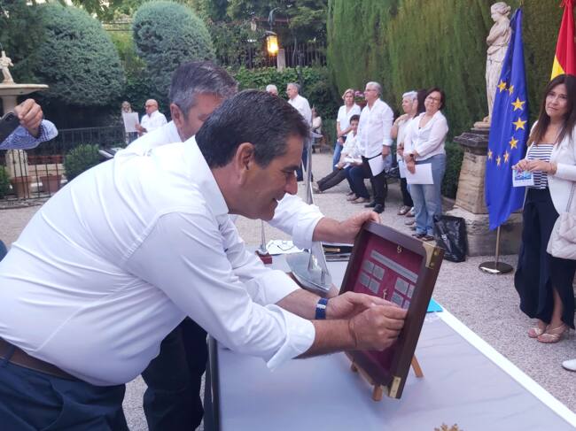 Roque Espí colocando la placa del barco alcoyano vencedor en la pasada regata, el Ruaj