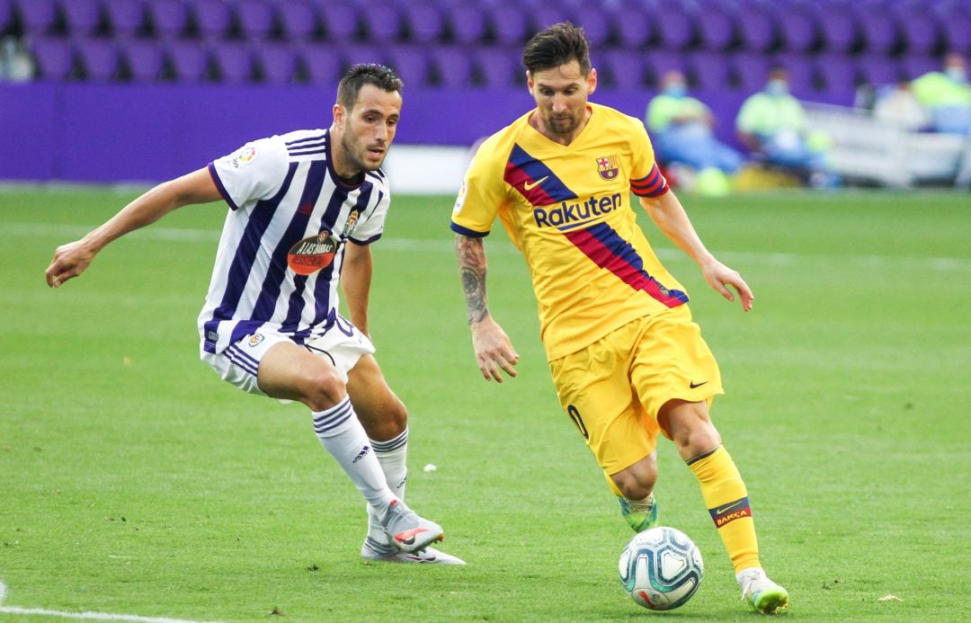 Lionel Messi of FC Barcelona and Kiko Olivas of Real Valladolid