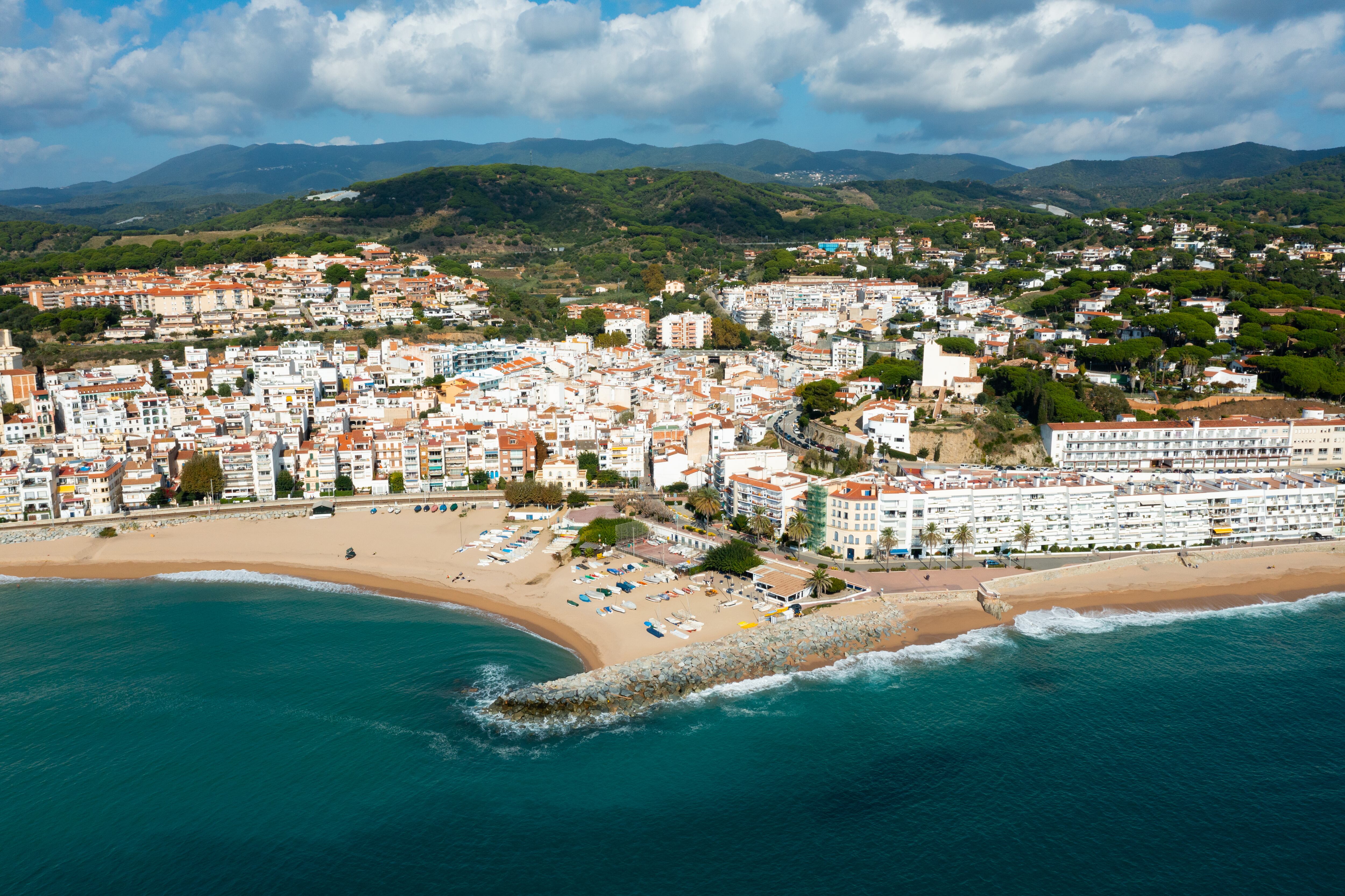 Aerial photo of Spanish municipality Sant Pol de Mar with view of beach and residential buildings.