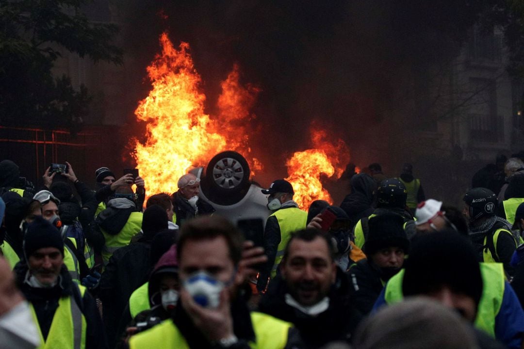 Manifestantes con chalecos amarillos se enfrentan a la policía cerca del Arco del Triunfo de París, Francia