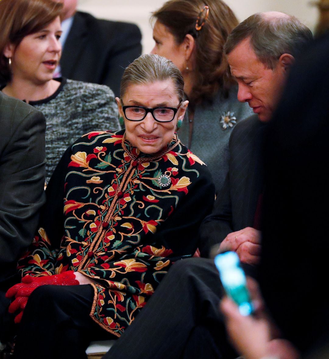 FILE PHOTO: U.S. Supreme Court Associate Justice Ruth Bader Ginsburg talks with Chief Justice John Roberts as they attend a ceremony where President Donald Trump awardee the 2018 Presidential Medals of Freedom in the East Room of the White House in Washington.