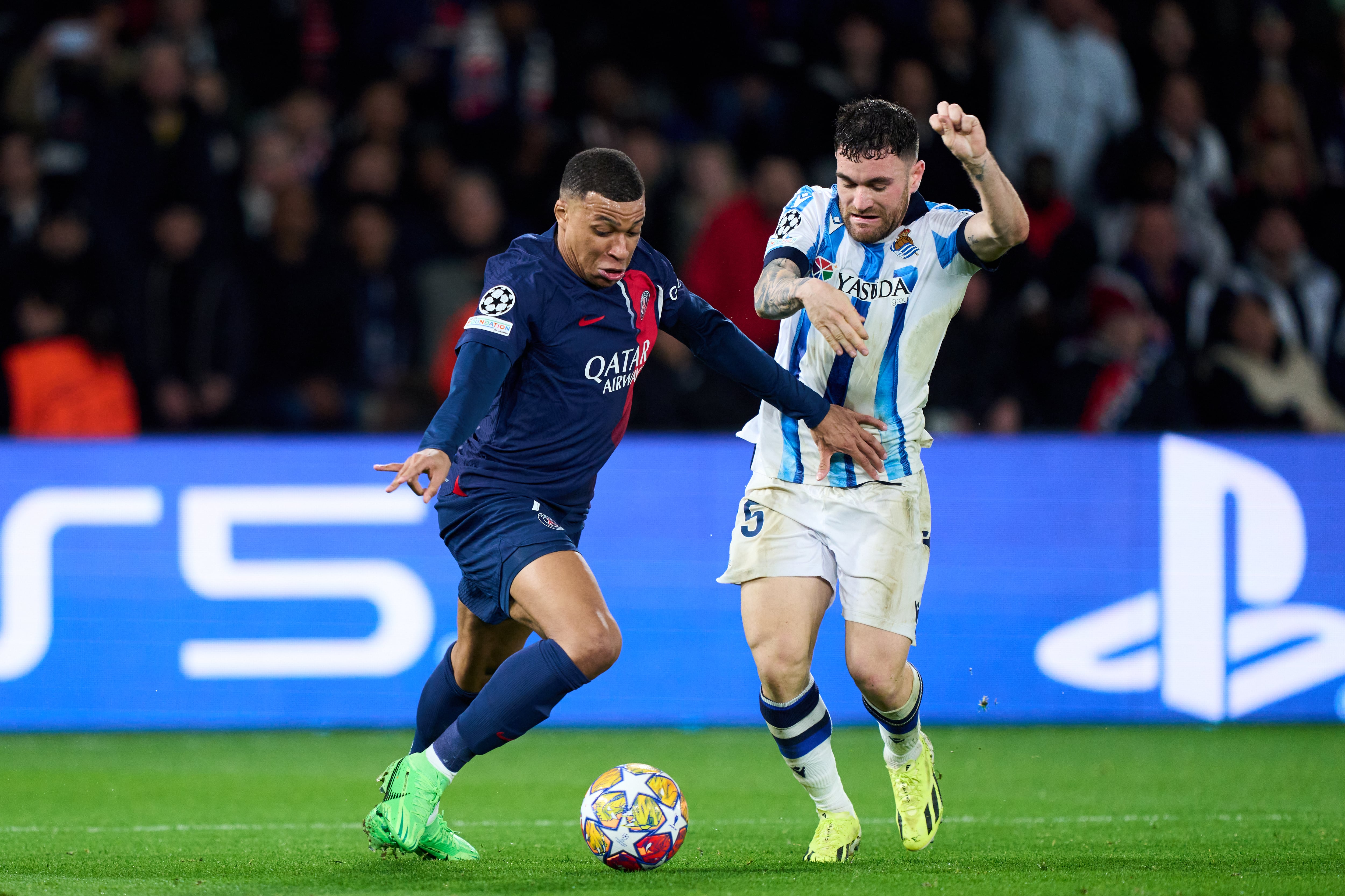 PARIS, FRANCE - FEBRUARY 14: Kylian Mbappe of Paris Saint-Germain duels for the ball with Javi Galan of Real Sociedad during the UEFA Champions League 2023/24 round of 16 first leg match between Paris Saint-Germain and Real Sociedad at Parc des Princes on February 14, 2024 in Paris, France. (Photo by Juan Manuel Serrano Arce/Getty Images)