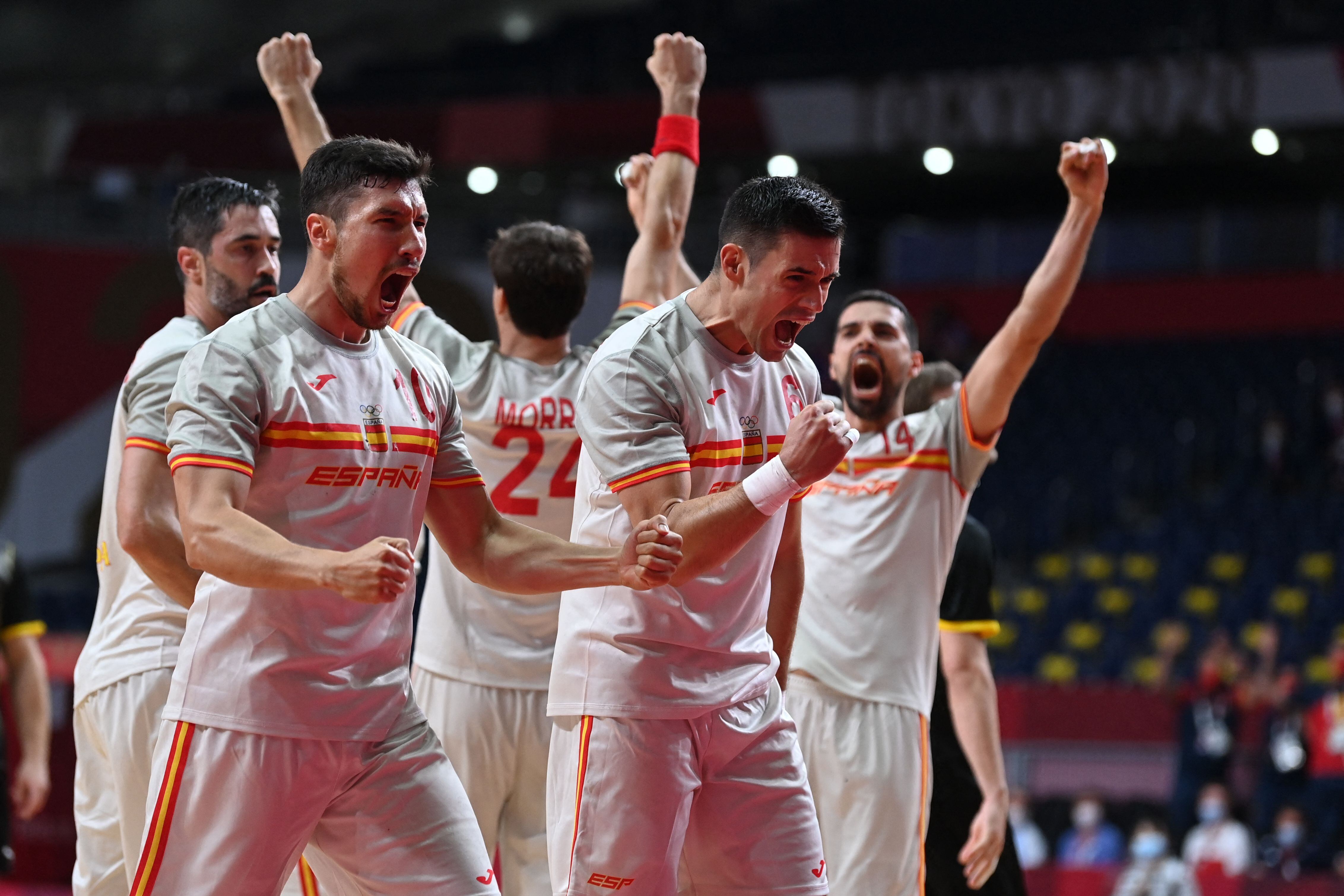 Spain&#039;s right back Alex Dujshebaev (L) and Spain&#039;s wing Angel Fernandez celebrate their victory after the men&#039;s preliminary round group A handball match between Germany and Spain of the Tokyo 2020 Olympic Games at the Yoyogi National Stadium in Tokyo on July 24, 2021. (Photo by Daniel LEAL / AFP) (Photo by DANIEL LEAL/AFP via Getty Images)