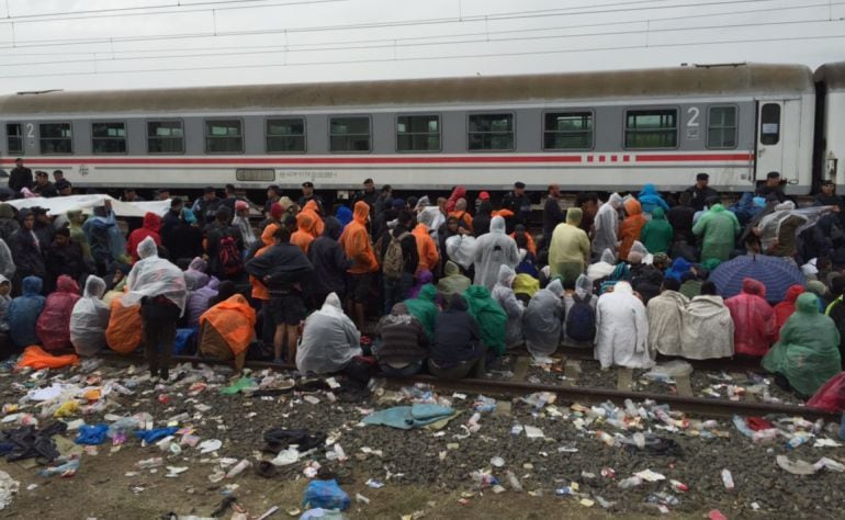 Miles de personas esperan bajo la lluvia para poder cruzar la frontera