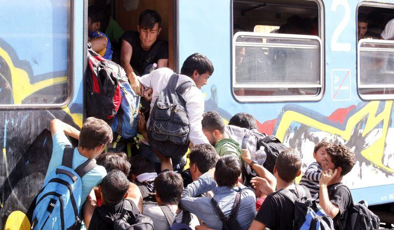 Refugiados se empujan entre sí para subir a bordo de un tren rumbo a Zagreb en la estación de Beli Manastir (Croacia).