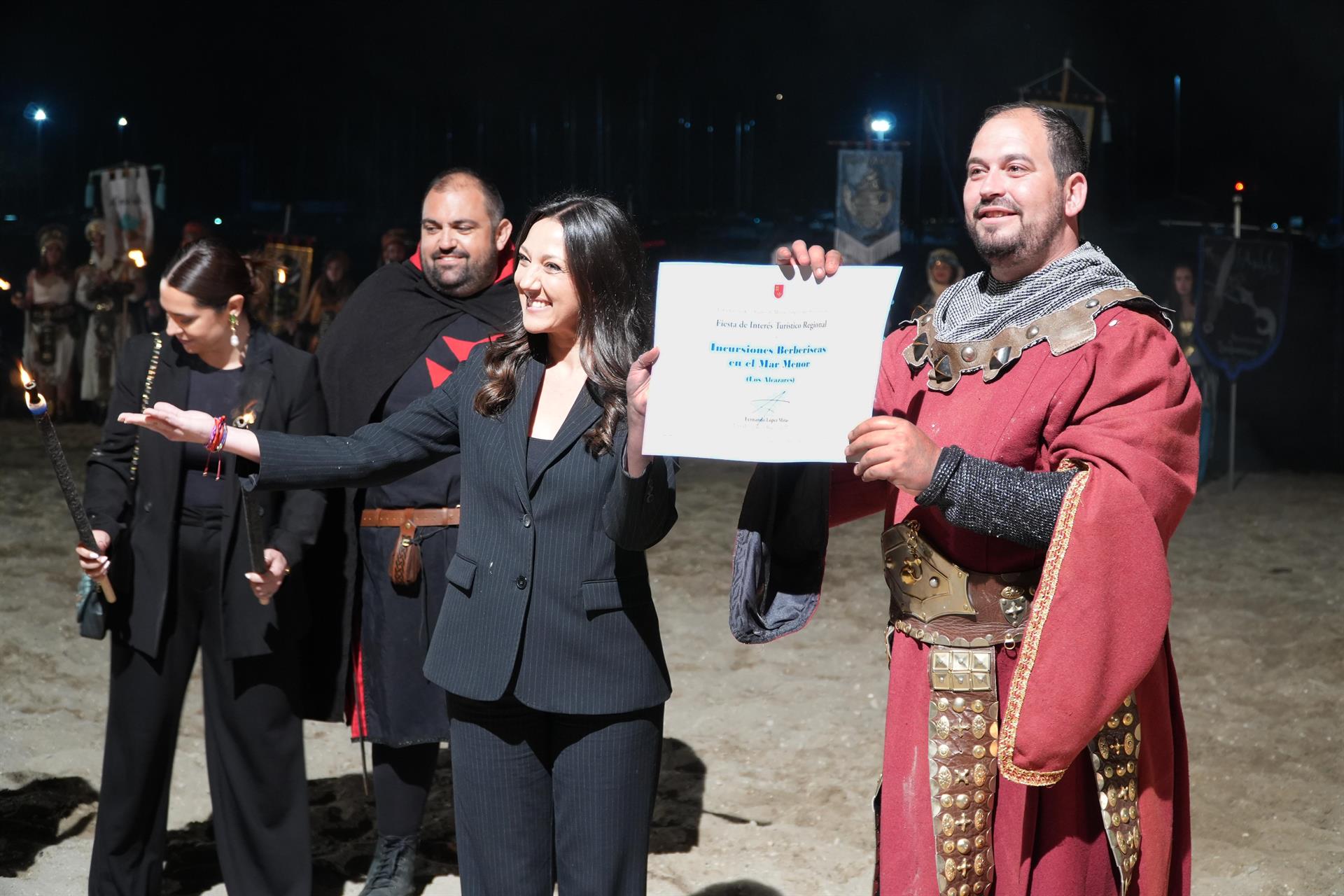 La consejera de Turismo, Cultura, Juventud y Deportes, Carmen Conesa, entrega al alcalde de Los Alcázares, Mario Pérez Cervera, el certificado de que las fiestas de las Incursiones Berberiscas ya son de Interés Turístico Regional
