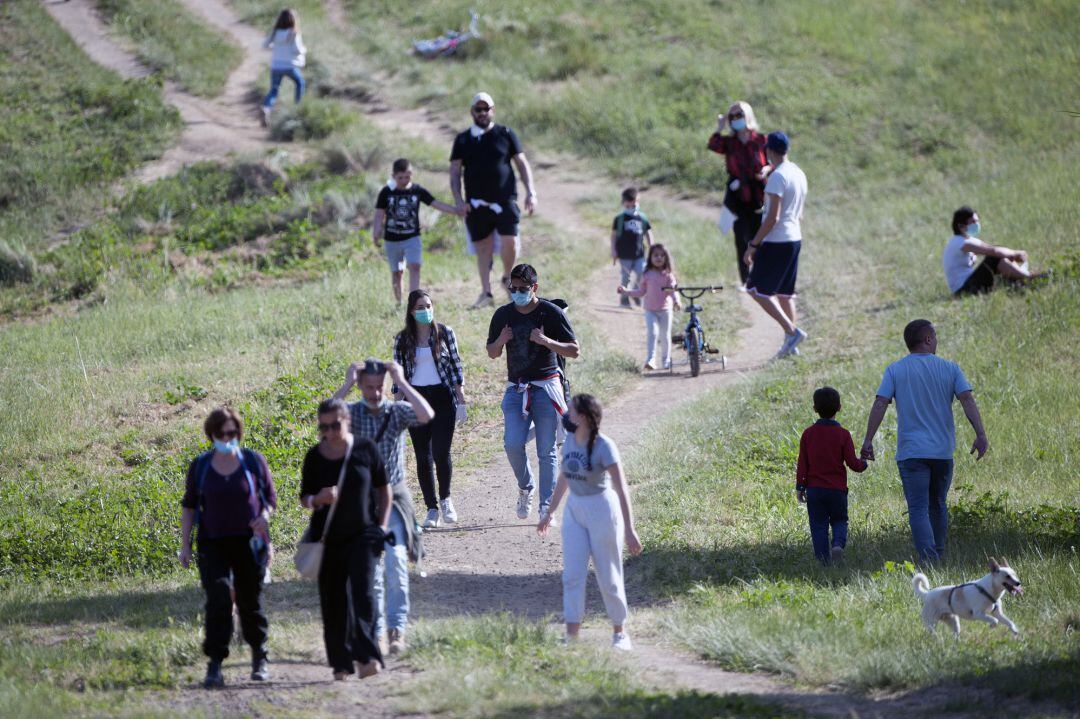 Varias personas pasean por un parque en Roma