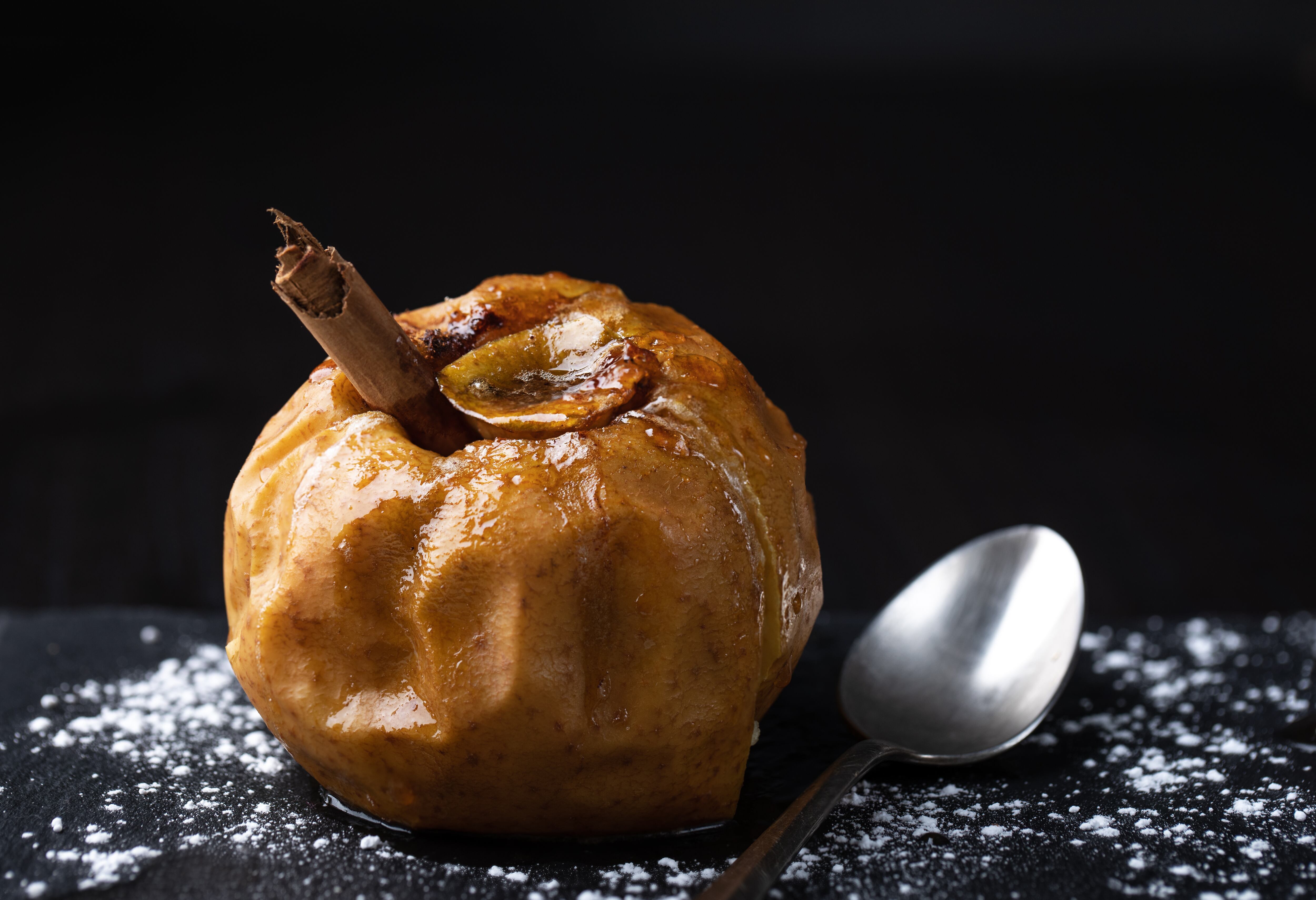 Close up of baked apple stuffed with butter, cinnamon and sugar
