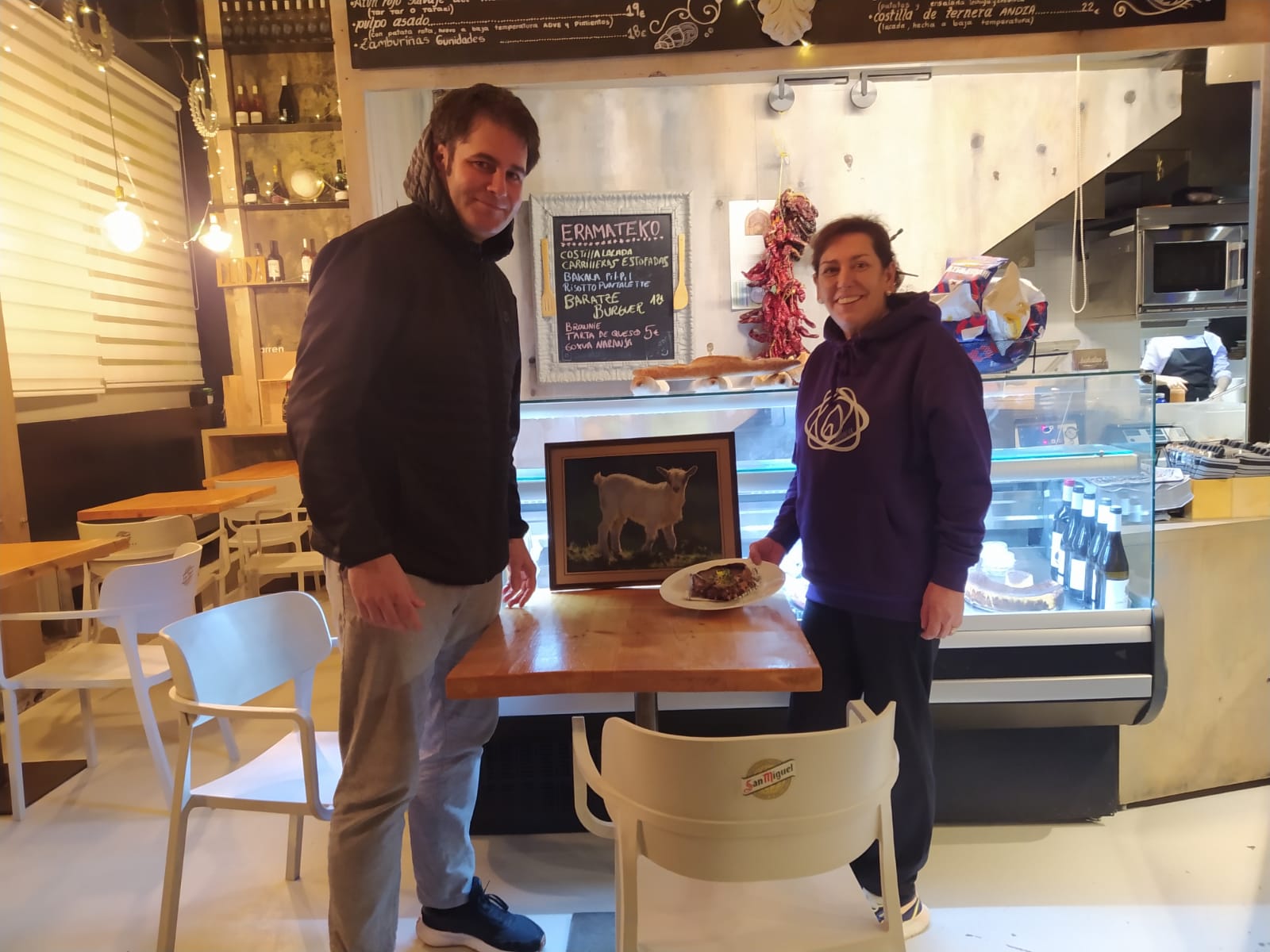 Unai Altuna y Mireia Alonso, con el cuadro de Esteban Oroz, posan en el &#039;Baratze&#039; de Eibar