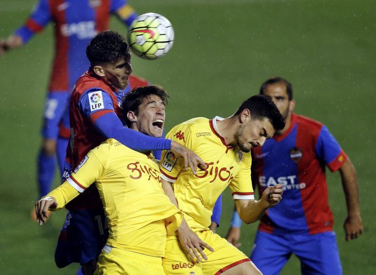 El defensa argelino del Levante Carl Medjani (i) y los jugadores del Sporting luchan por el balón durante el partido de la trigésimo primera jornada de Liga que disputan en el estadio Ciutat de Valencia. EFE-Juan Carlos Cárdenas