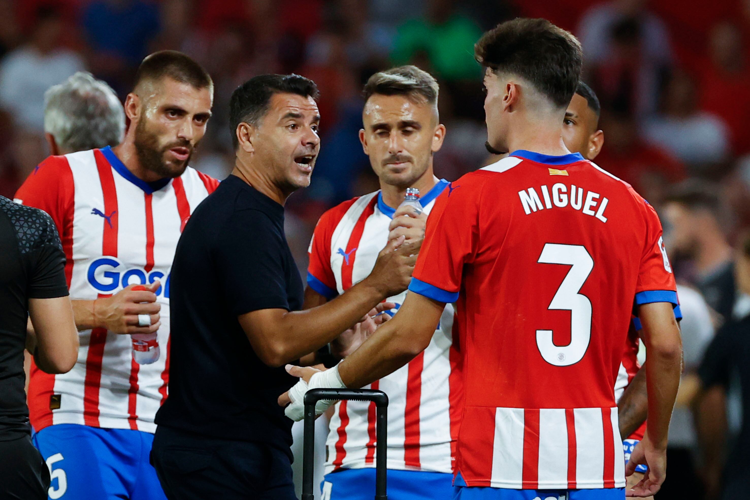 SEVILLA, 26/08/2023.- Miguel Ángel Sánchez "Michel" (c), entrenador del Girona, habla con sus jugadores en una pausa de hidratación durante el partido ante el Sevilla de la jornada 3 de LaLiga que estos dos equipos juegan hoy sábado en el estadio Sánchez Pizjuán.. EFE/Julio Muñoz