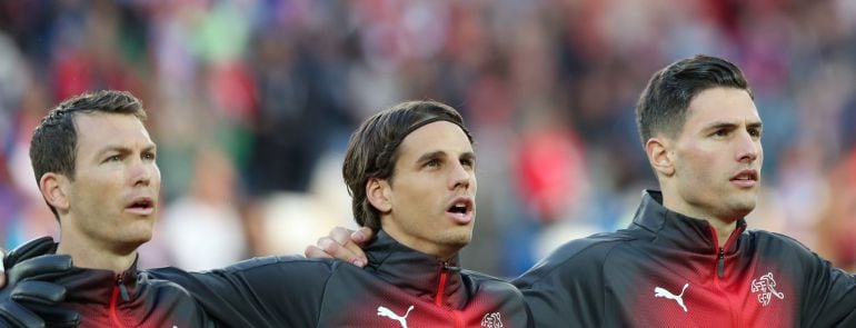 Stephan Lichtsteiner, Yann Sommer and Fabian Schar line up during the national anthems before the match  