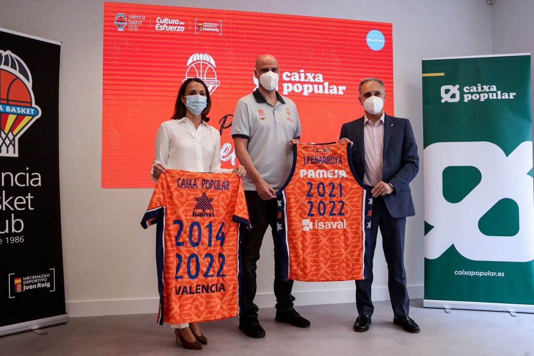 (L-R) Alicia Soler Area, Director of Caixa Popular, Joan Penarroya and Jose Puentes, Valencia Basket Director, pose for photo with the official t-shirt during the presentation of Joan Penarroya as new coach of Valencia Basket at the Caixa Popular offices 