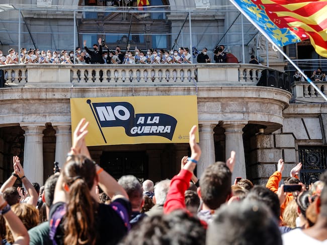 Cartel de "No a la guerra" en el balcón del Ayuntamiento de València durante la primera mascletá de las Fallas de 2022