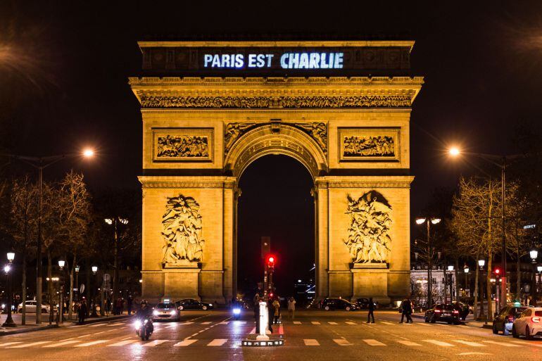 PARIS, FRANCE - JANUARY 09: The words Paris Est Charlie &#039;Paris is Charlie&#039; are projected onto the Arc de Triomphe on January 9, 2015 in Paris, France. According to reports, three suspects in the deadly attack at the offices of the satirical magazine Charl