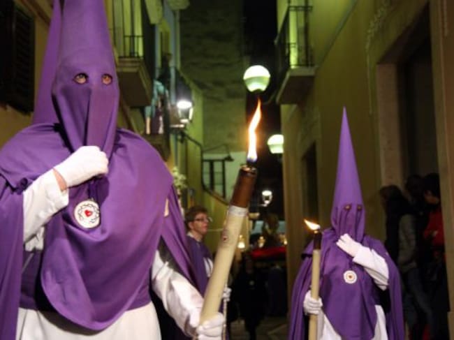Dues persones vestides amb vestes durant la processó del Sant Enterrament de Tarragona.