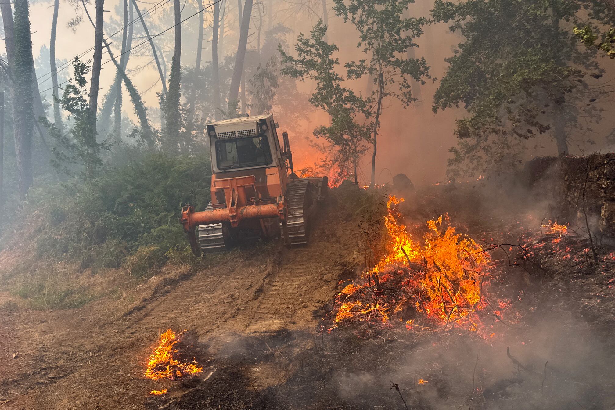 Labores de extinción este miércoles del incendio forestal declarado en las inmediaciones de A Cañiza. Los servicios de extinción lidian este miércoles en Galicia con hasta cinco incendios forestales de importante tamaño que afectan a las provincias de Lugo, Ourense y Pontevedra y que, de forma acumulada, han quemado más de 155 hectáreas de terreno. EFE/ Sxenick