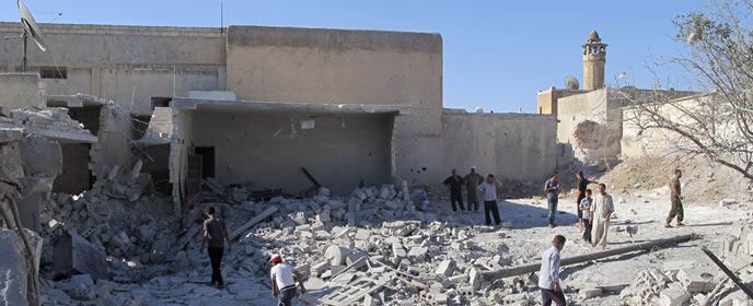 Habitantes de la localisad siria de Hazano inspeccionan sus casas tras un bombardeo efectuado por las tropas leales a Al Assad.