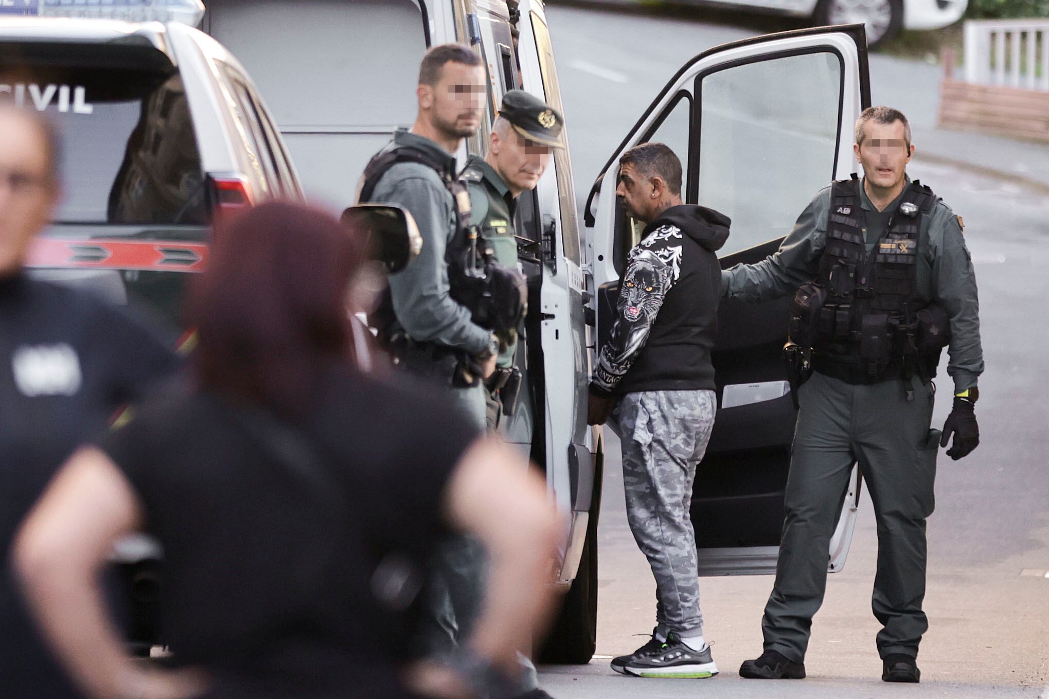 ARTEIXO (A CORUÑA) , 06/11/2024.- Agentes de la Guardia Civil dirigen a uno de los detenidos al vehículo policial que se los ha trasladado a comisaría este miércoles durante un operativo antidroga que se está desarrollando en el lugar de Meicende, del concello coruñés de Arteixo (A Coruña) y en el que han sido detenidas cuatro personas. EFE/Cabalar
