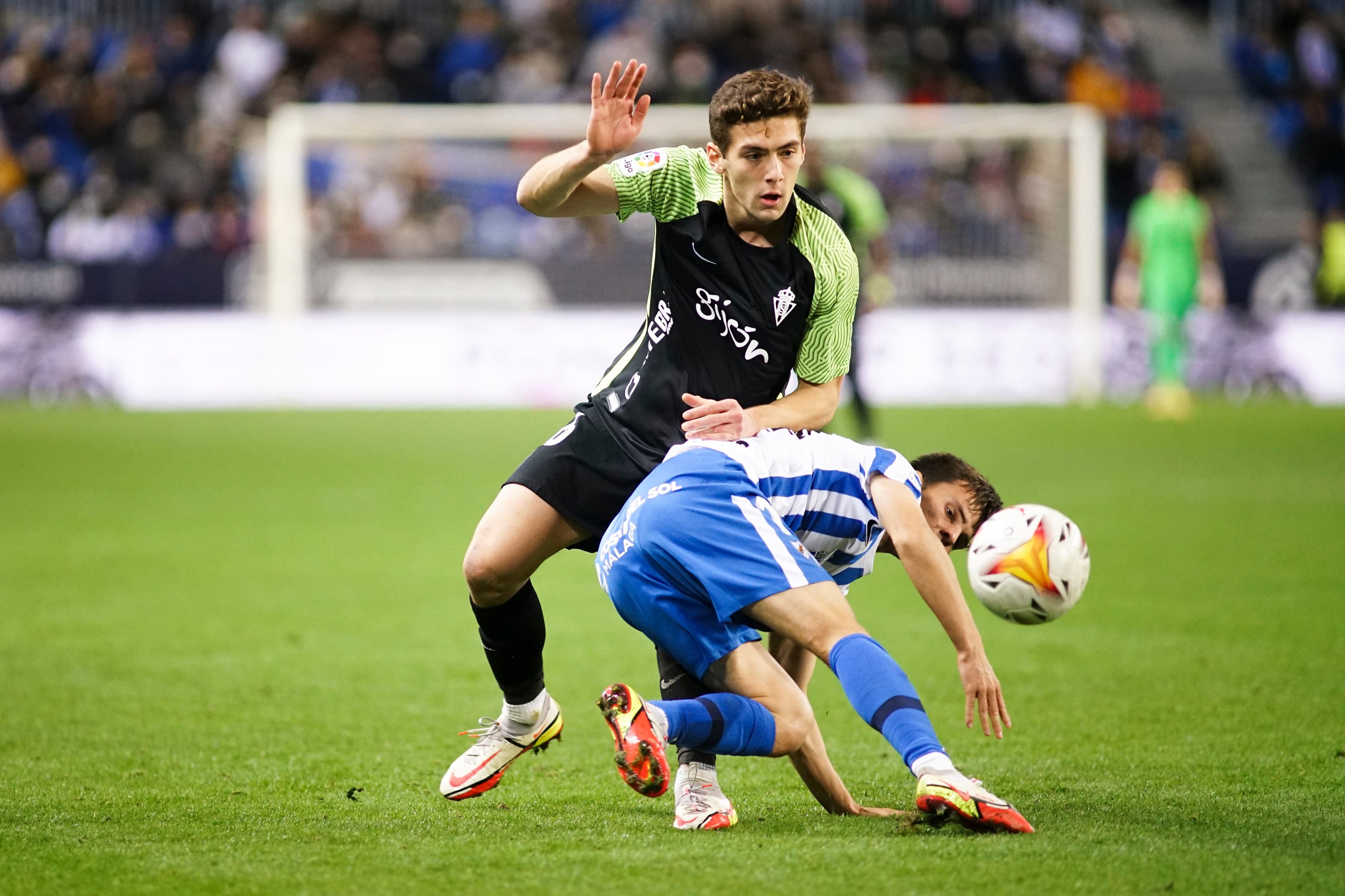 MALAGA, SPAIN - 2022/01/09: Jose Gragera (L) of Real Sporting and Aleix Febas (R) of Malaga CF are seen  in action during the La Liga Smartbank 2021/2022 match between Malaga CF and Real Sporting at La Rosaleda Stadium in Malaga(Final score; Malaga CF 2:2 Real Sporting). (Photo by Francis Gonzalez/SOPA Images/LightRocket via Getty Images)