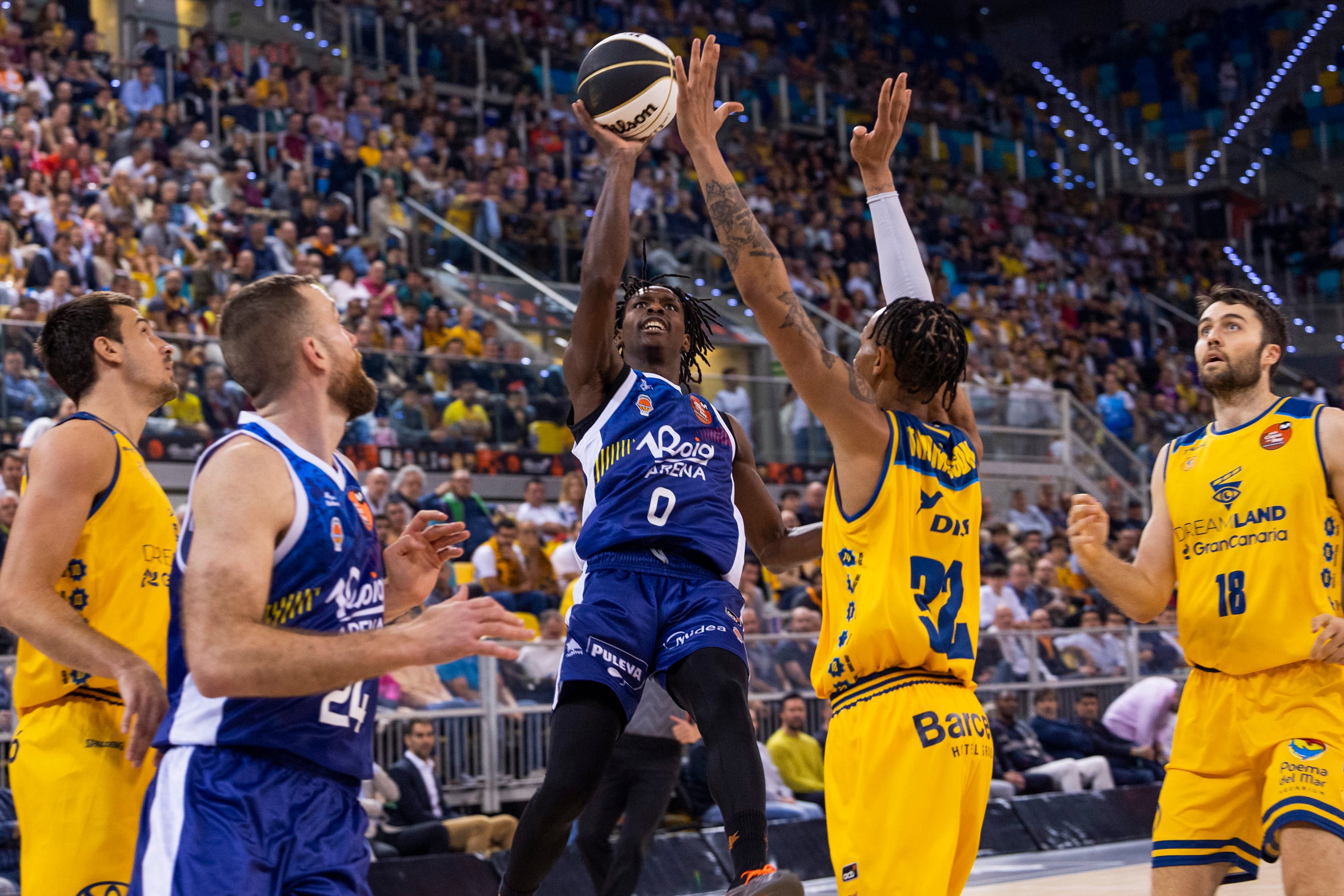 LAS PALMAS DE GRAN CANARIA, 14/02/2025.- El base senegalés del Valencia Basket Brancou Badio (c) lanza ante el base de Georgia del Gran Canaria Joe Thomasson (2d), durante el partido de cuartos de final de la Copa del Rey entre el Dreamland Gran Canaria y el Valencia Basket, este viernes en el Gran Canaria Arena de Las Palmas. EFE/ Quique Curbelo
