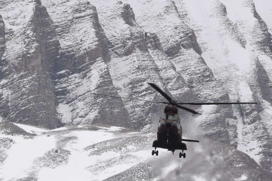 A helicopter flies near Seyne, south-eastern France, on March 25, 2015, near the site where a Germanwings Airbus A320 crashed in the French Alps. A German airliner crashed near a ski resort in the French Alps on March 24, killing all 150 people on board, 