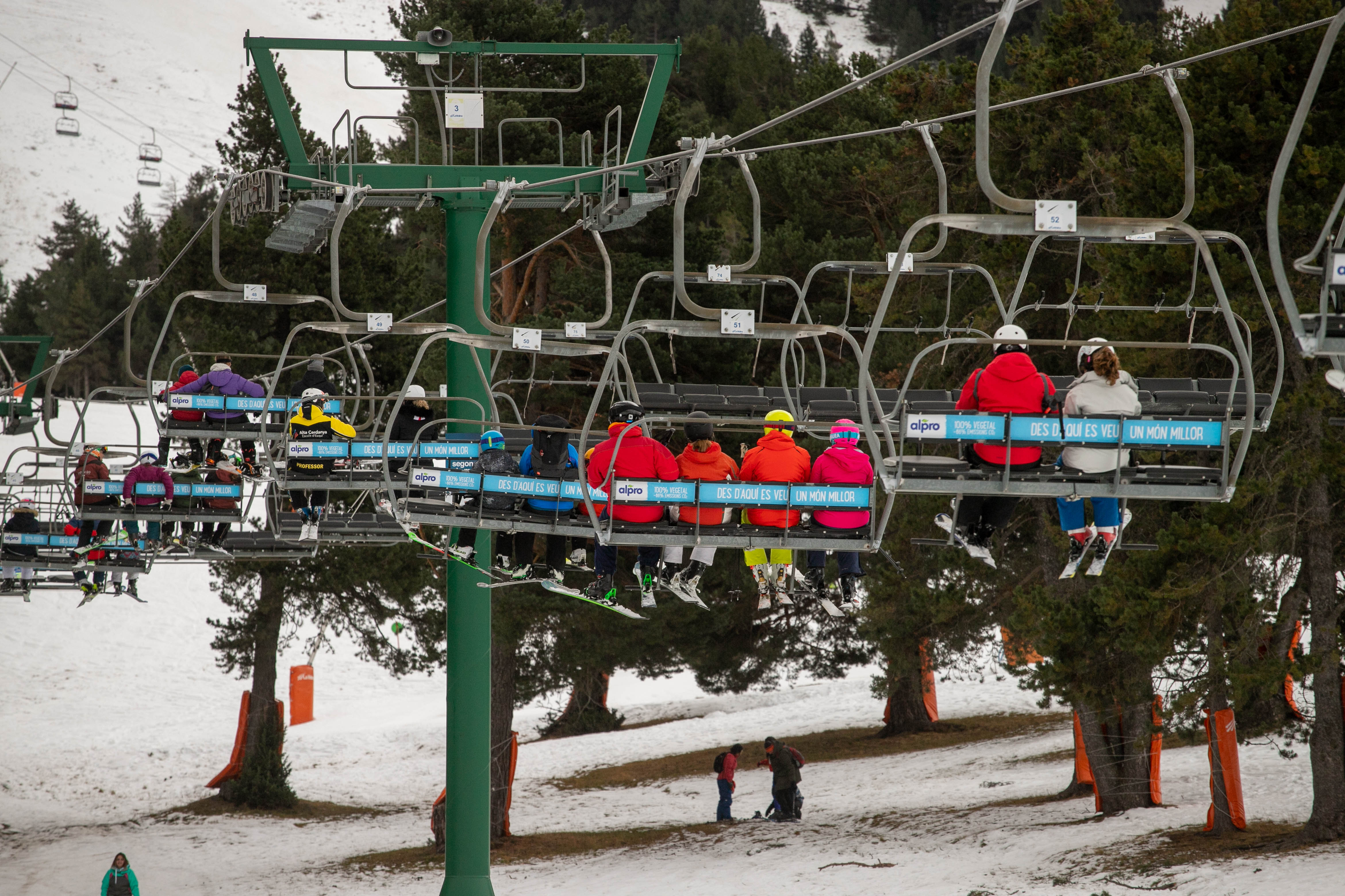 GIRONA, CATALONIA, SPAIN - DECEMBER 08: Several people on the ski lift at the resort of La Molina, on December 8, 2022, Girona, Catalonia, Spain.