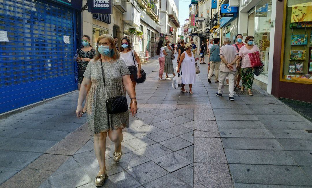 Personas con mascarilla en la calle Santa Eulalia de Mérida