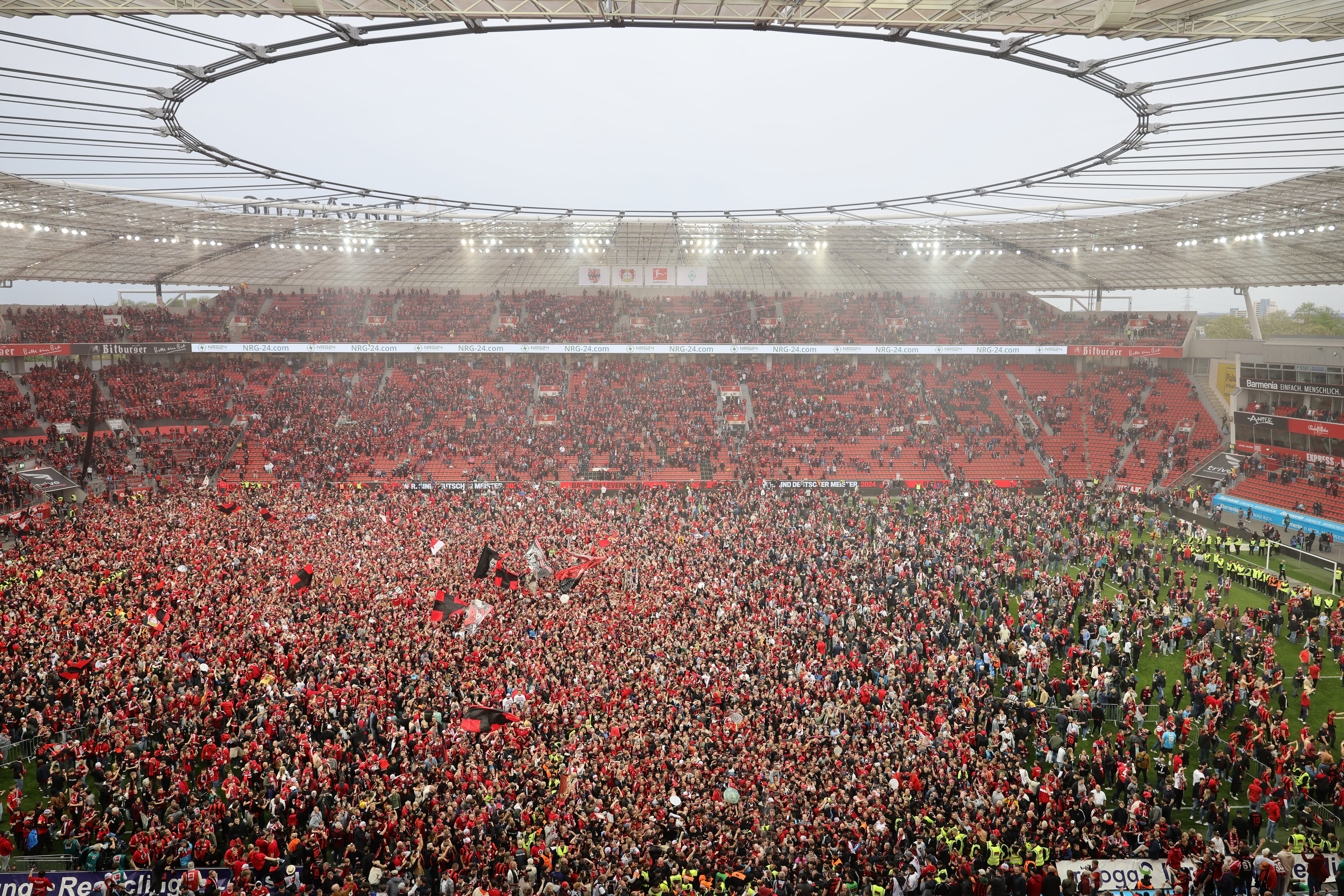 LEVERKUSEN, GERMANY - APRIL 14: Fans of Bayer 04 Leverkusen invade the pitch after their team&#039;s victory and winning the Bundesliga title for the first time in their history in the Bundesliga after the match between Bayer 04 Leverkusen and SV Werder Bremen at BayArena on April 14, 2024 in Leverkusen, Germany. (Photo by Andreas Rentz/Getty Images) (Photo by Andreas Rentz/Getty Images)