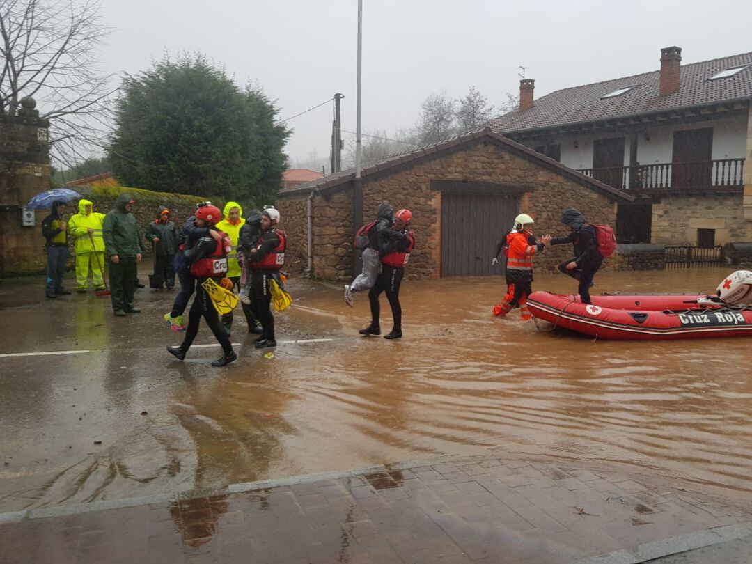 Los servicios de Cruz Roja evacúan a niños en Cantabria por las inundaciones.