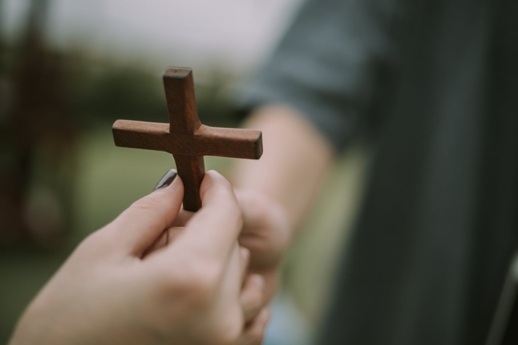 Hand with cross .Concept of hope, faith, christianity, religion, church online.