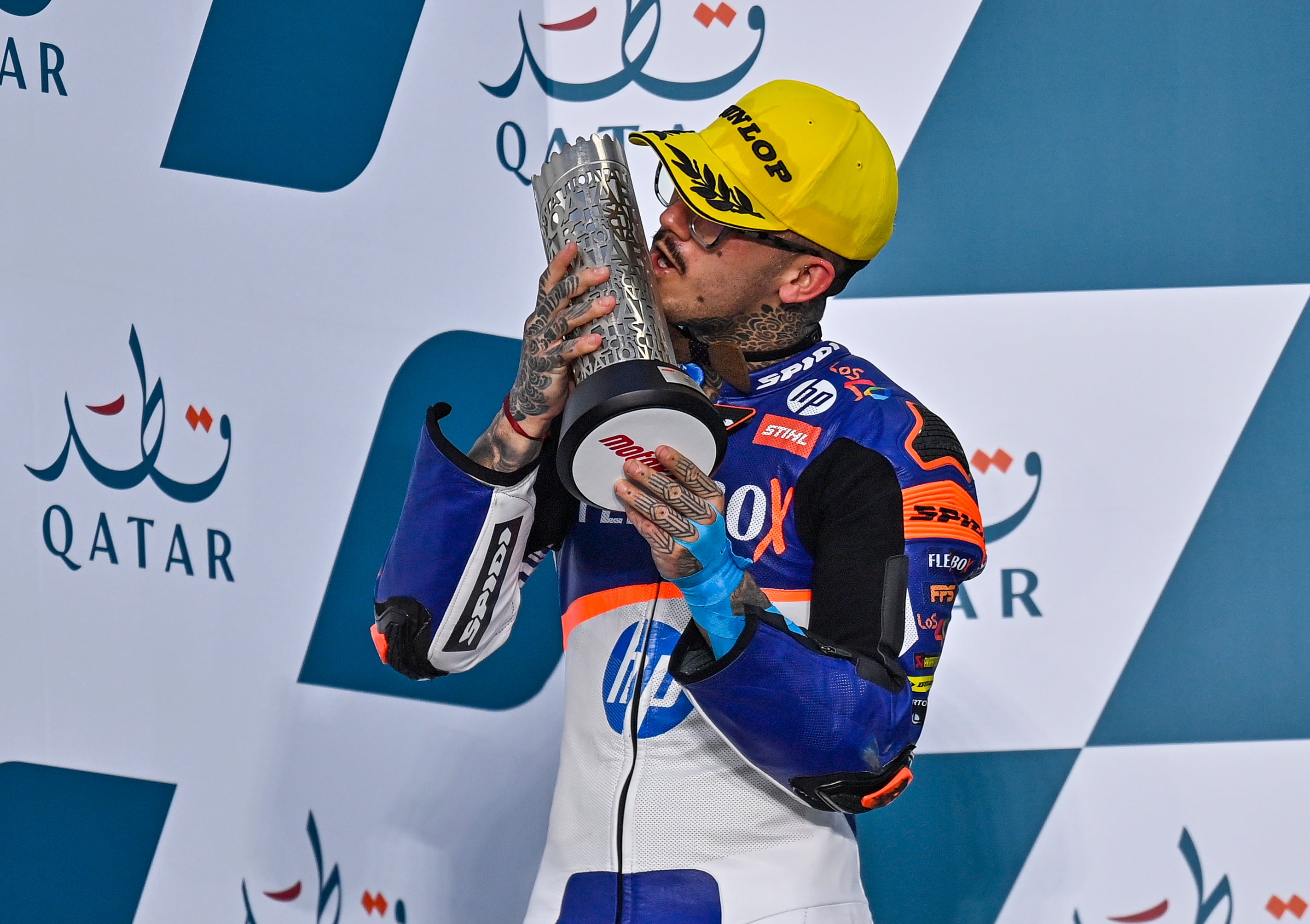 Doha (Qatar), 06/03/2022.- Spanish Moto2 rider Aron Canet of the Flexbox HP40 team celebrates on the podium after taking the second place in the Moto2 race of the Motorcycling Grand Prix of Qatar at Losail International Circuit in Doha, Qatar, 06 March 2022. (Motociclismo, Ciclismo, Catar) EFE/EPA/NOUSHAD THEKKAYIL
