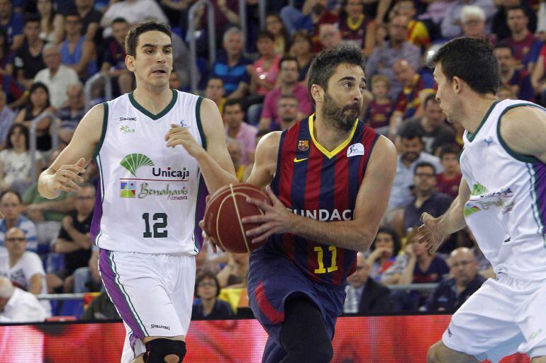 Juan Carlos Navarro se escapa entre los jugadores del Unicaja Carlos Suárez y Ryan Toolson