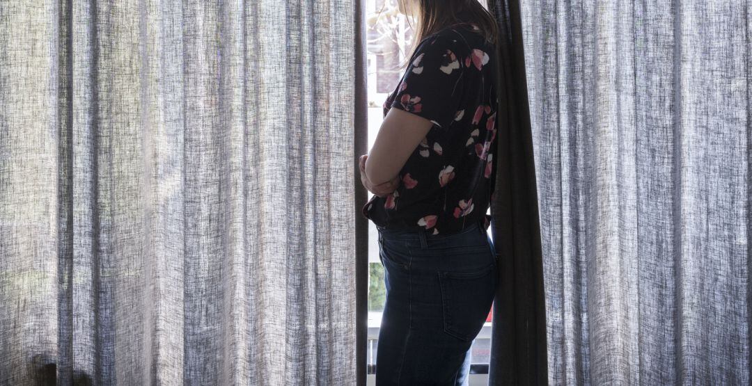 Imagen de recurso de una mujer embarazada mirando por la ventana