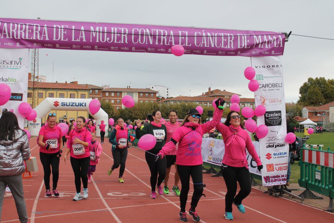 Participantes en la carrera de la mujer celebran su llegada a meta