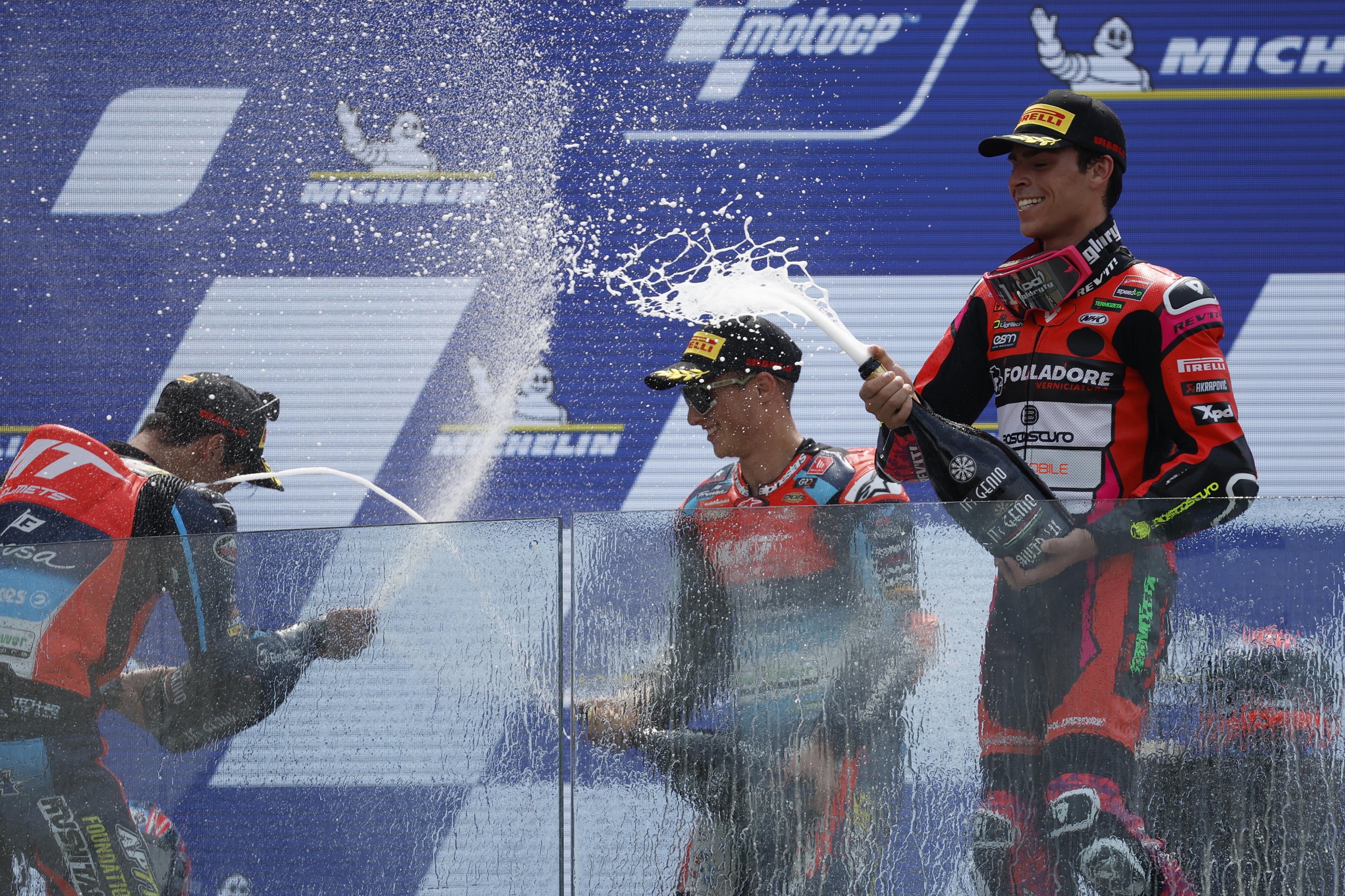 Le Mans (France), 12/05/2024.- (L-R) Second place winner Japanese Moto2 rider Ai Ogura, of MT Helmets - MSI team, First place winner Spanish rider Sergio Garcia of the MT Helmets - MSI Team, Third place winner Moto2 Spanish rider Alonso Lopez of SpeedUp Racing, celebrate on podium after winning the Moto2 race at the French Motorcycling Grand Prix in Le Mans, France, 12 May 2024. (Motociclismo, Ciclismo, Francia, Japón) EFE/EPA/YOAN VALAT
