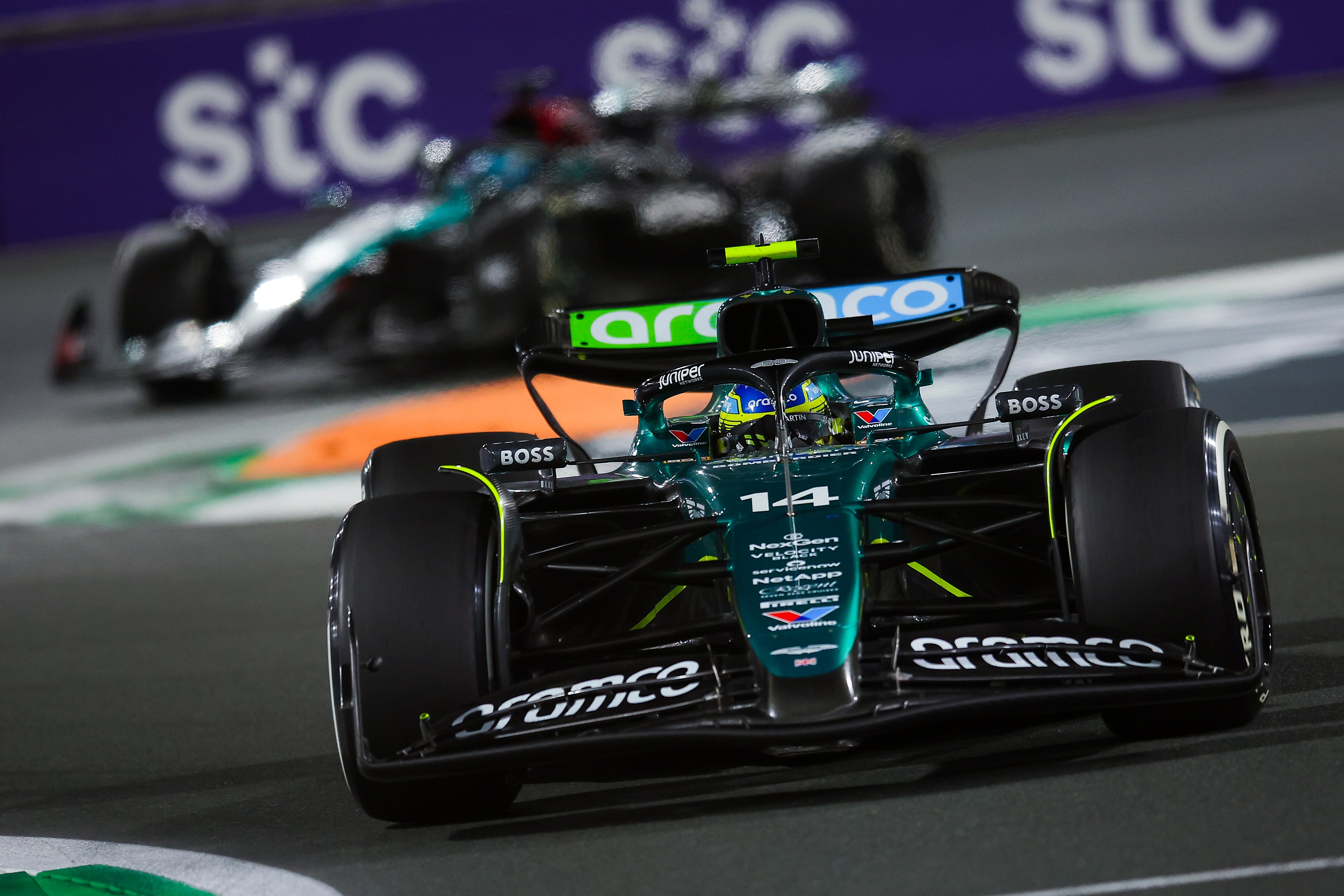 JEDDAH, SAUDI ARABIA - MARCH 09: Fernando Alonso of Spain driving the (14) Aston Martin AMR24 Mercedes on track and George Russell of Great Britain driving the (63) Mercedes AMG Petronas F1 Team W15 on track during the F1 Grand Prix of Saudi Arabia at Jeddah Corniche Circuit on March 09, 2024 in Jeddah, Saudi Arabia. (Photo by Eric Alonso/Getty Images)