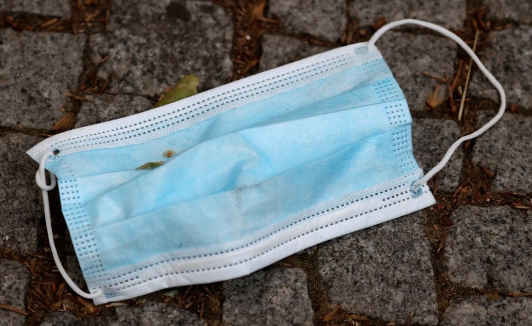 A used face mask is pictured on a street, following coronavirus disease (COVID-19) outbreak in Berlin,