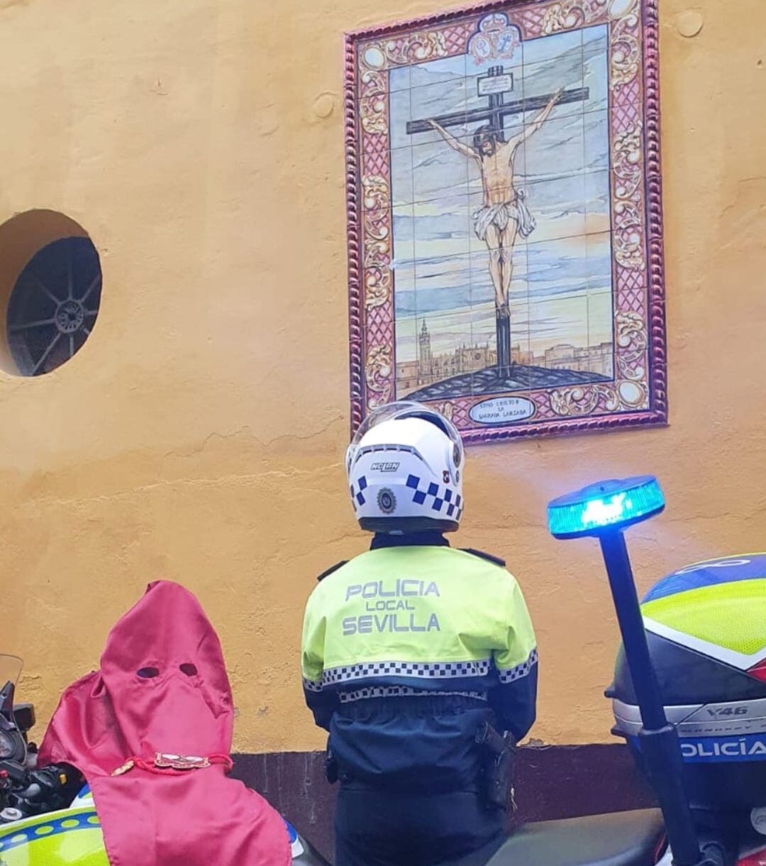 Un patruyero de la policía local de Sevilla se para a rezar ante uno de los azulejos de la iglesia de San Martín