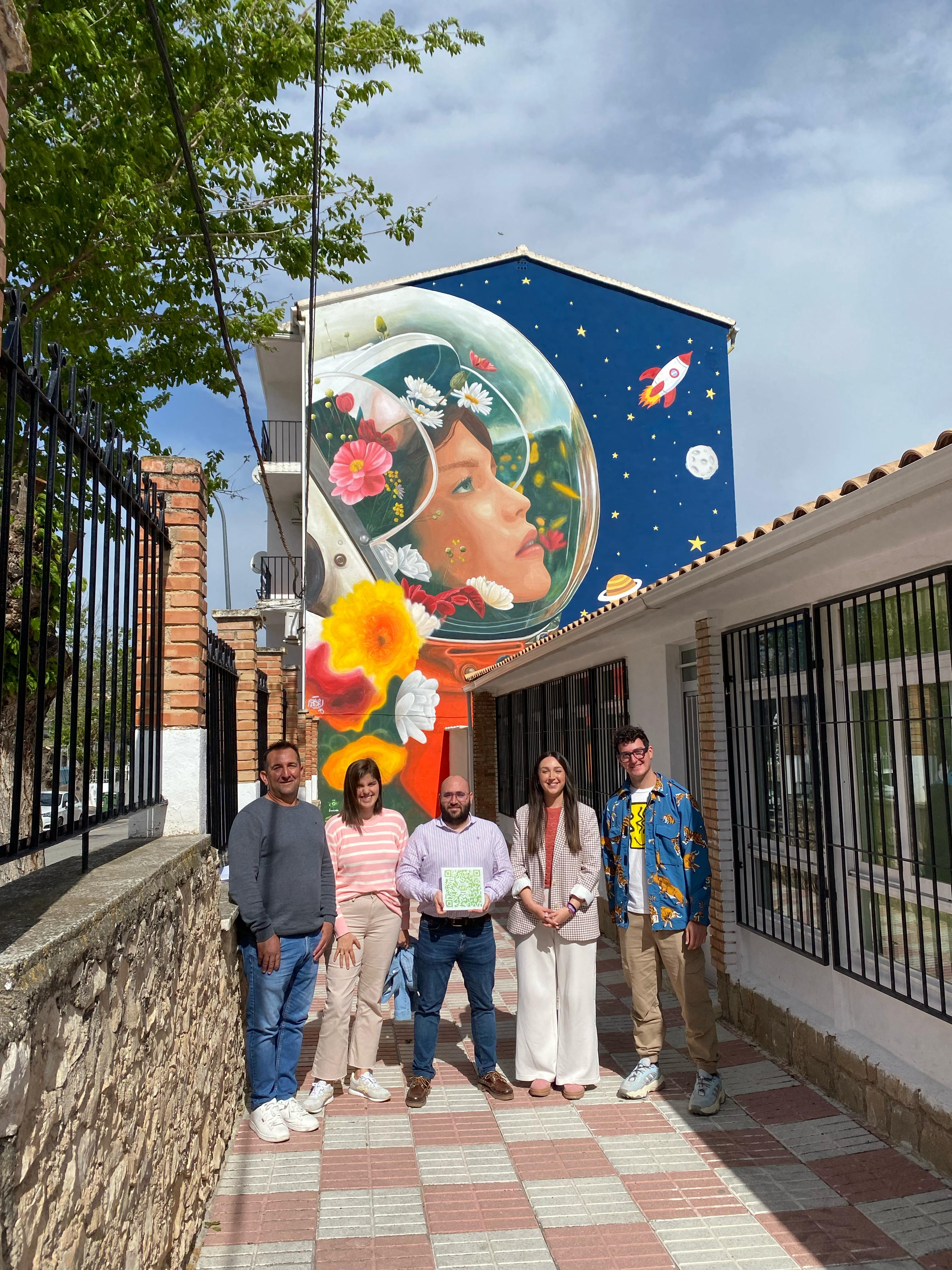 Responsables políticos y el autor del grafiti, Javi Aldarias, delante de su obra en Jimena.