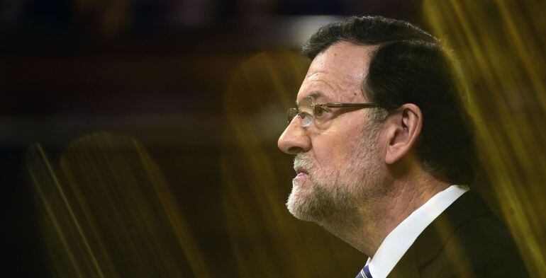 Spanish Prime Minister Mariano Rajoy  listens during a debate on the state of the nation at the Congress of Deputies  ("Las Cortes") building in Madrid on February 24, 2015. Although not in the Spanish constitution the debate has been established as a parliamentary process almost annually since 1983 and covers the main issues of the economy, employment, pensions, social benefits, terrorism, immigration, regional funding, the convergence with the European Union and foreign policy. AFP PHOTO / PIERRE-PHILIPPE MARCOU
