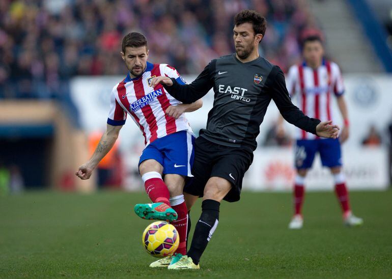 MADRID, SPAIN - JANUARY 03: Gabi Fernandez (L) of Atletico de Madrid competes for the ball with Nabil El Zhar of Levante UD (R) during the La Liga match between Club Atletico de Madrid and Levante UD at Vicente Calderon Stadium on January 3, 2015 in Madrid, Spain.  (Photo by Gonzalo Arroyo Moreno/Getty Images)